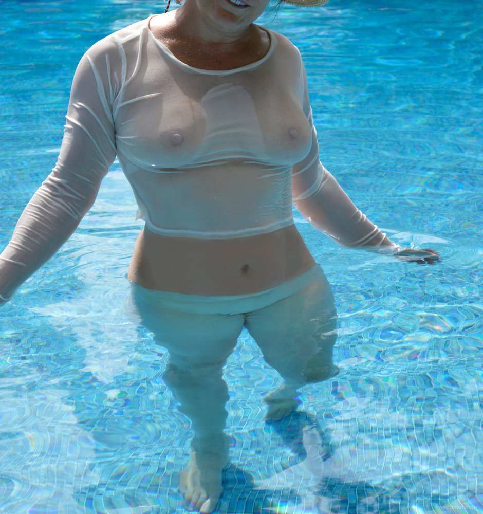 Wife having fun in the pool, she love to have photos made image