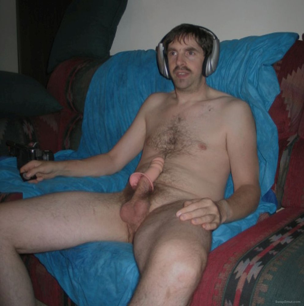 Male nudity having fun with an adult sex toy at home